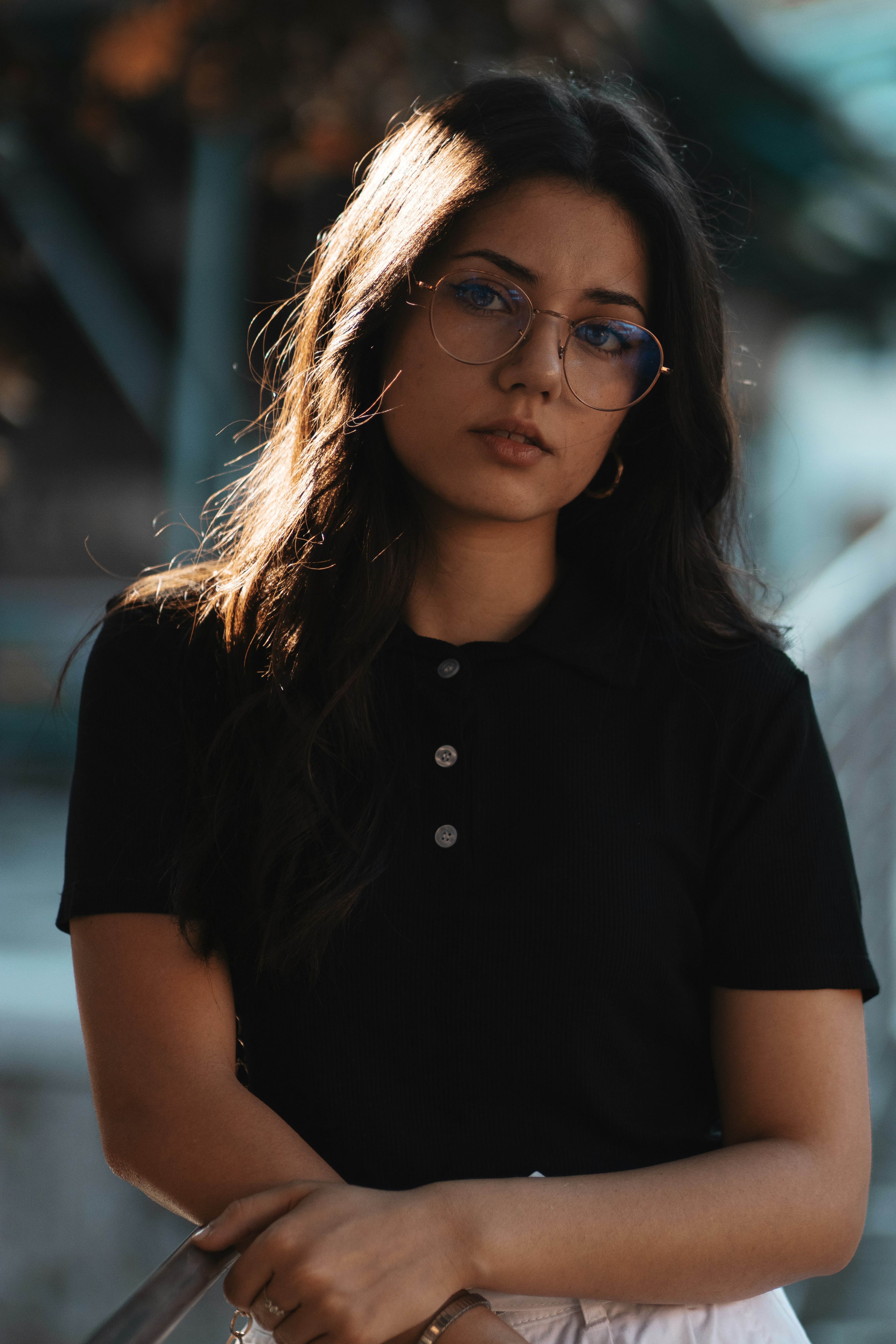 woman in black button up shirt wearing black framed eyeglasses